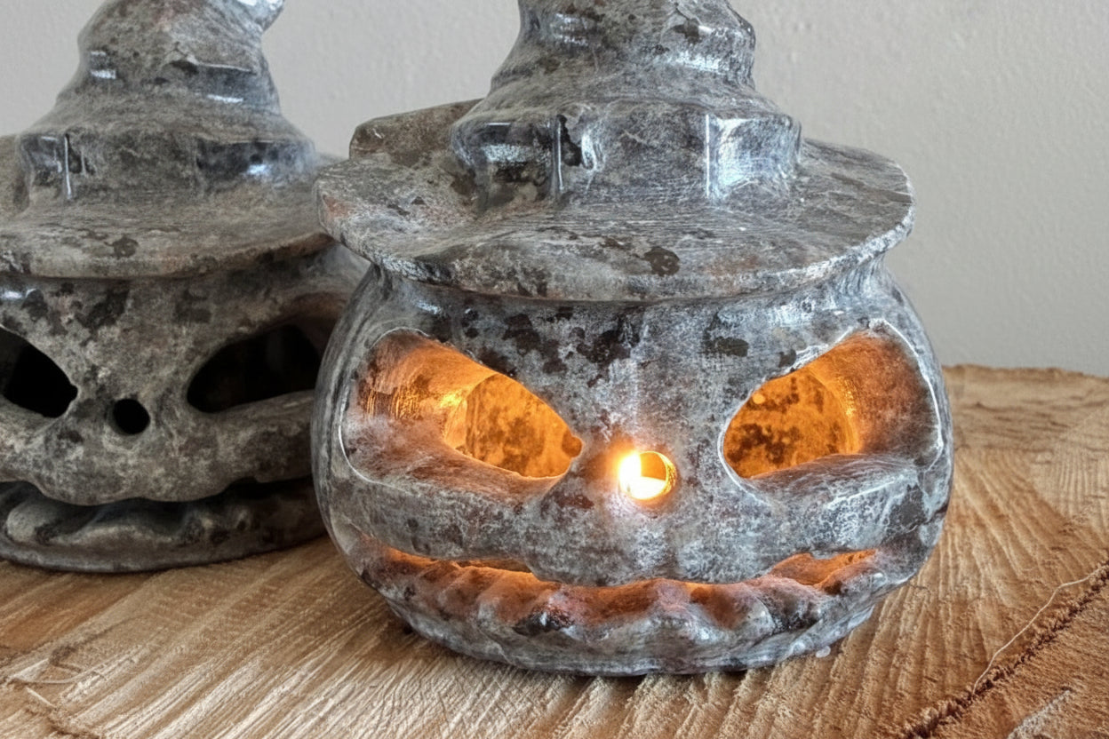Close up of a Yooperlite Crystal carved into a Jack O’Lantern sitting on a wood slab