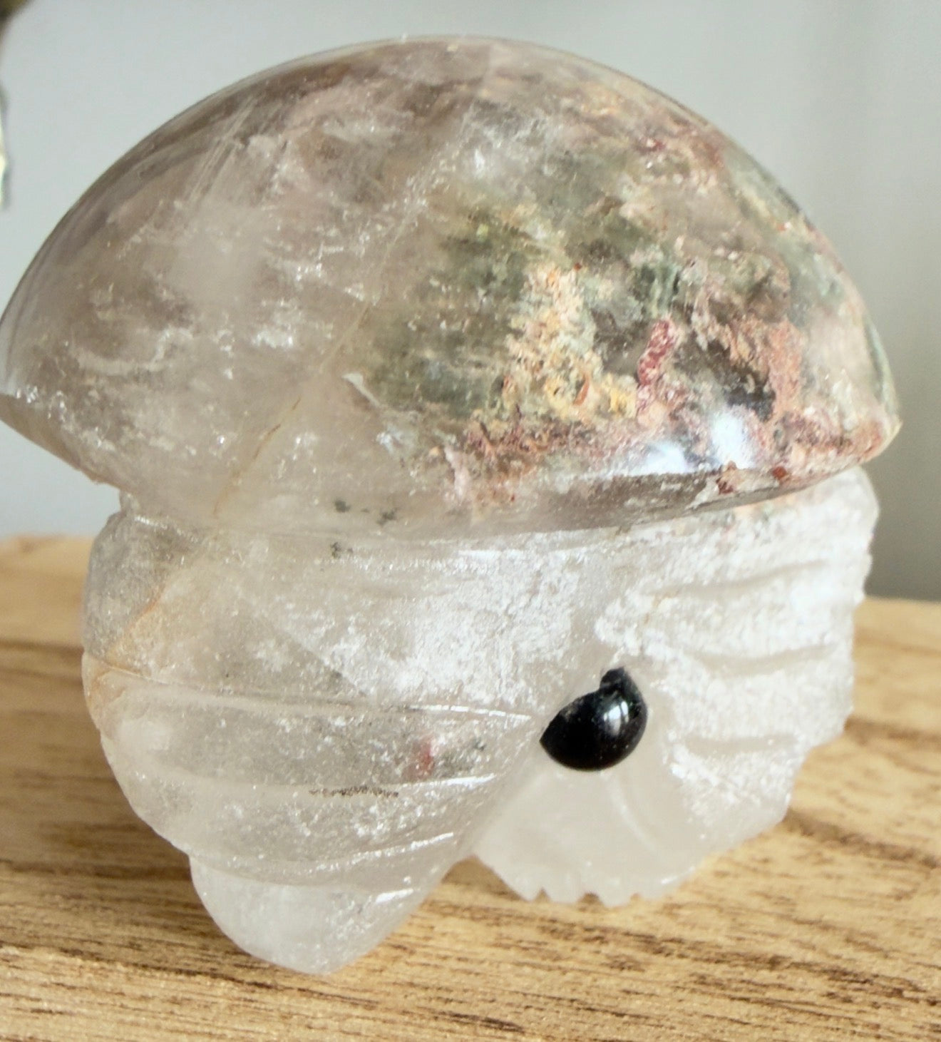 Garden Quartz Carved Elephant (B) crystal sculpture on wooden surface