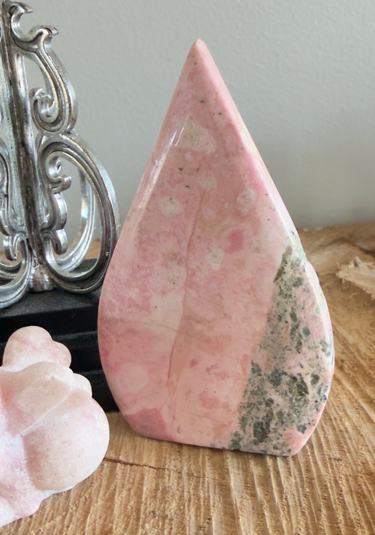 Rhodonite free form on a wood plank 