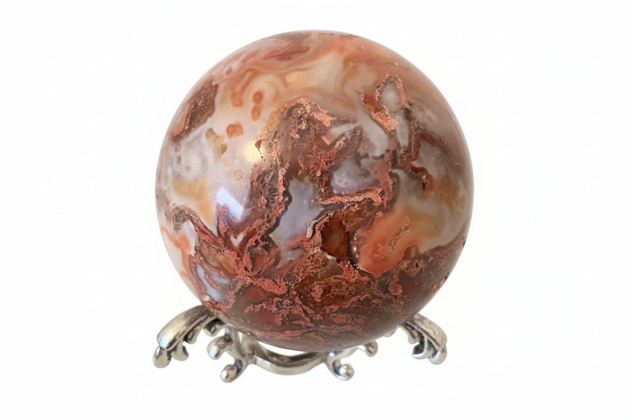 Close up of Carnelian Agate Sphere on a silvery stand