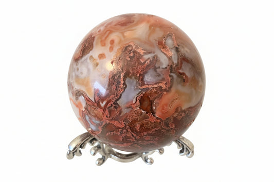 Close up of Carnelian Agate Sphere on a silvery stand