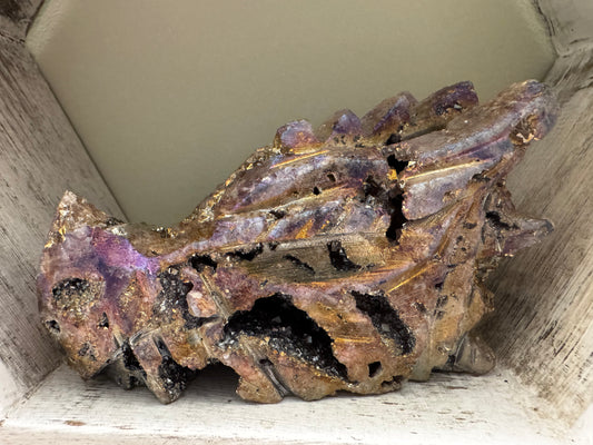 Amethyst and pyrite crystal formation in a decorative wooden box.