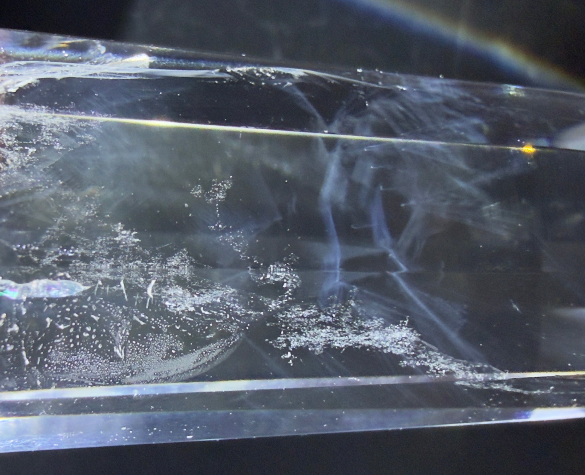 Close up of a clear quartz high quality double point prism with blue needle inclusion 