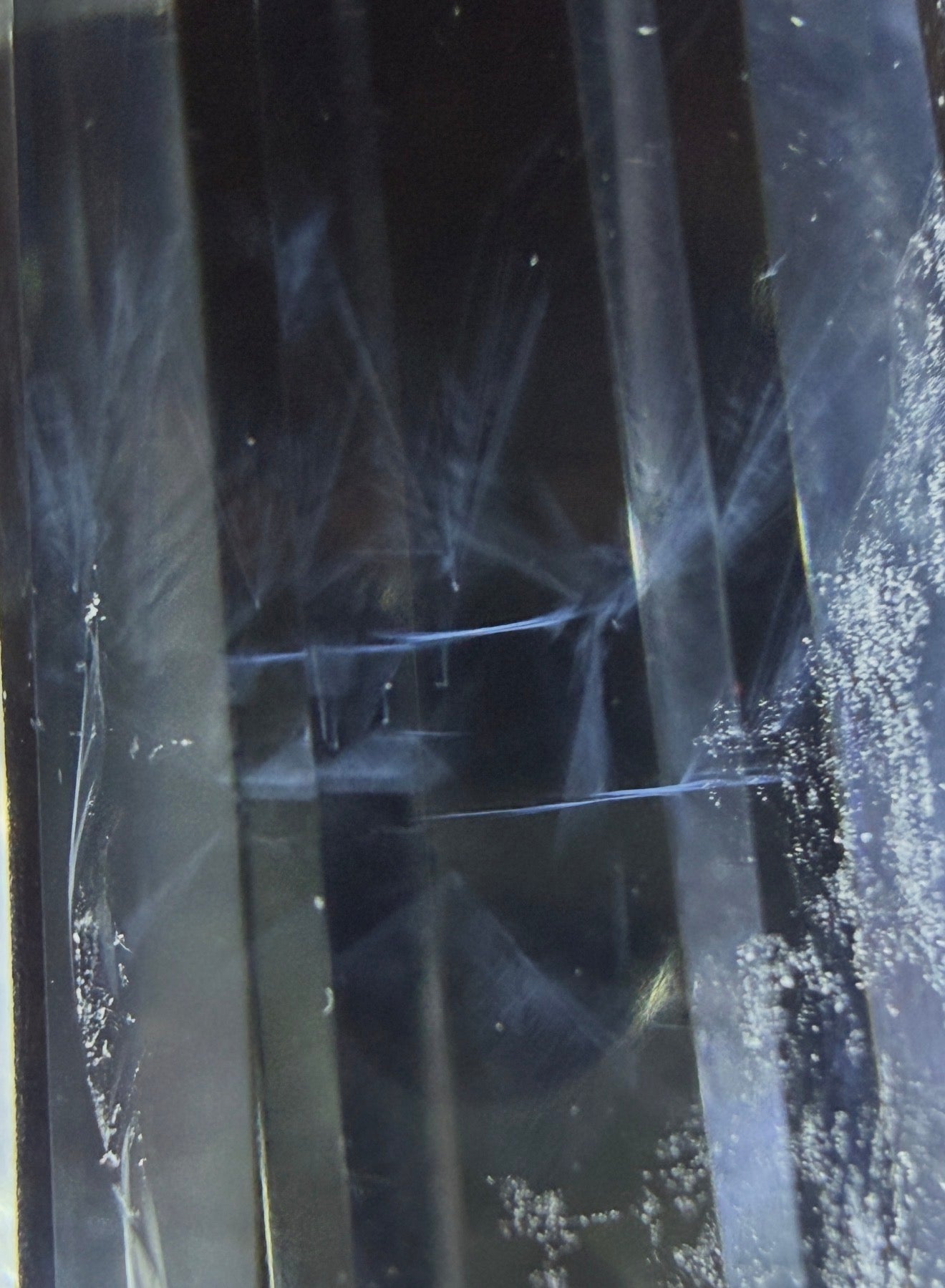 Close up of a clear quartz high quality double point prism with blue needle inclusion 