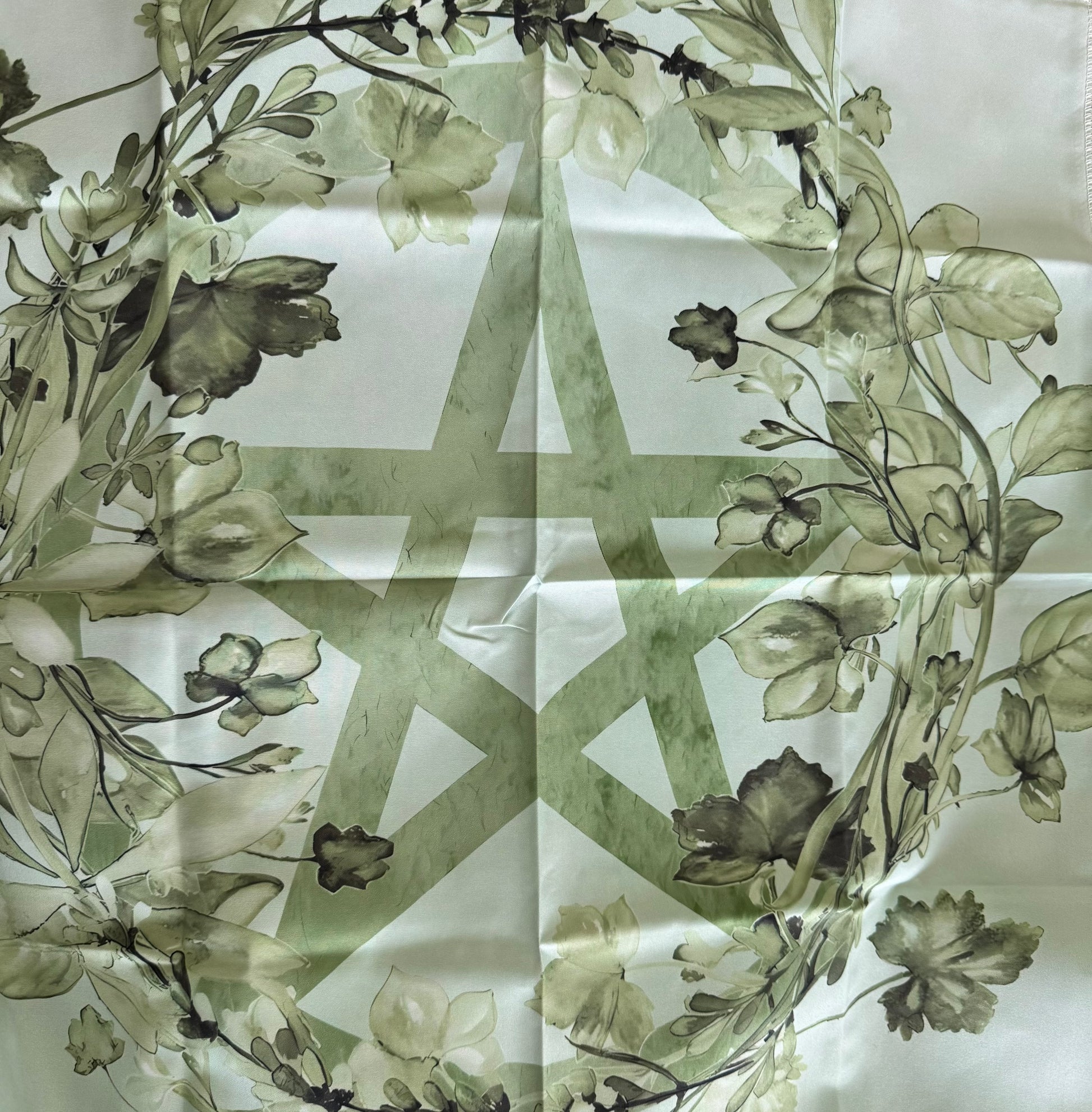 Silk scarf with a pentagram and floral design.