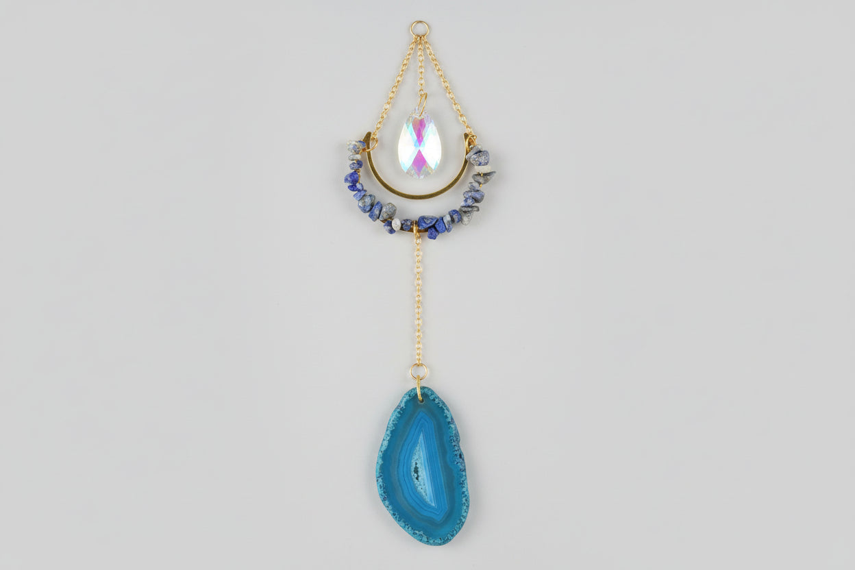 Sodalite suncatcher with blue agate on a plain background