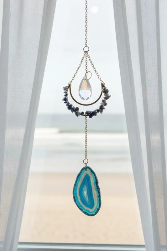 Sodalite suncatcher in a window with blue agate 
