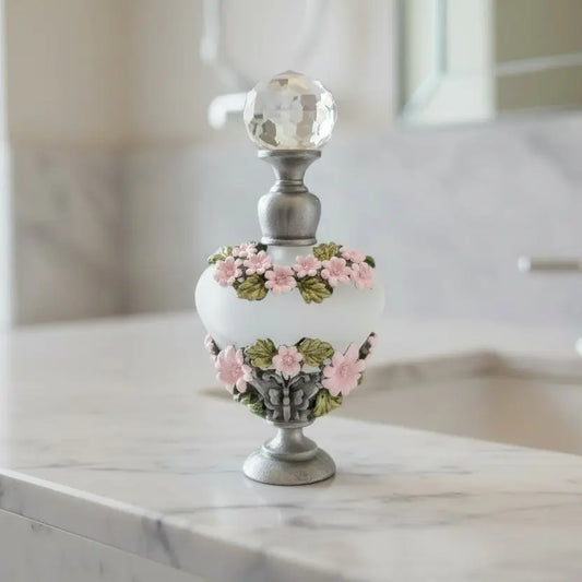 Vintage frosted glass decorative bottle with floral design and crystal topper