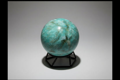 Amazonite Sphere colors teal, green, ivory sphere on a small stand with no background 