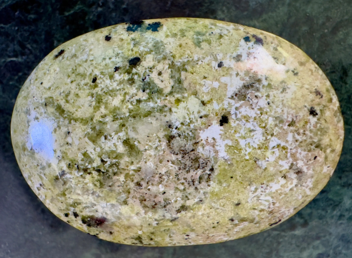 Polished, speckled, light green and white rock.