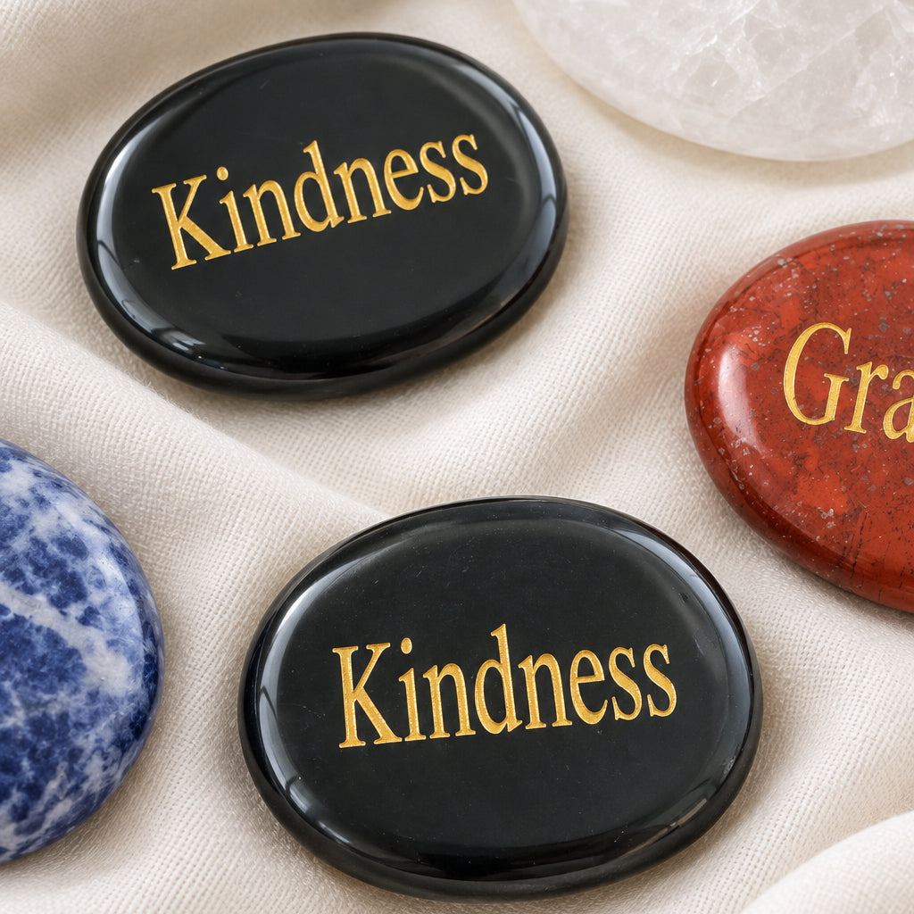 black obsidian carved worry stone with Kindness etched in a gold tone lettering