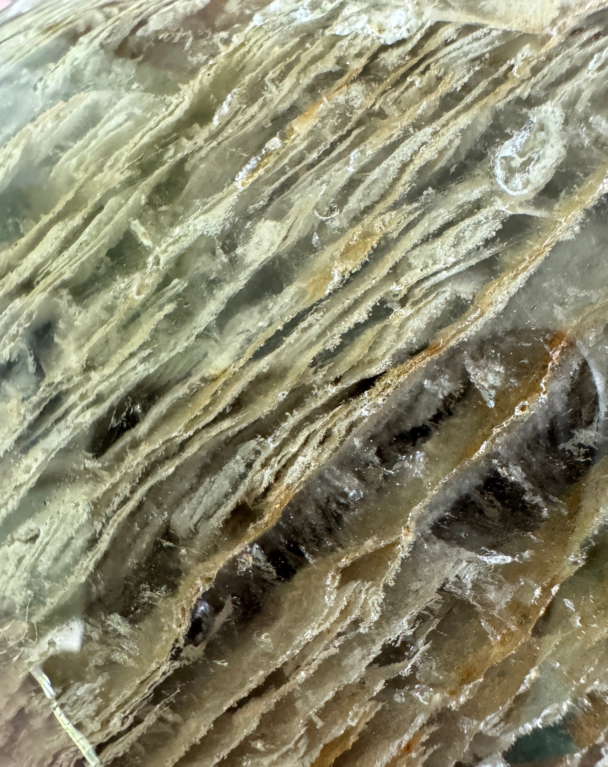 Close-up of a light-colored, striated mineral.