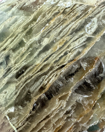 Close-up of a light-colored, striated mineral.