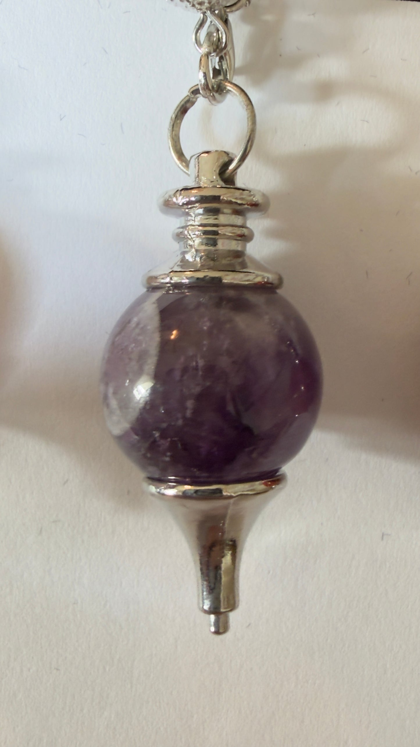 Assorted ball-shaped crystal dowsing pendulums with chains