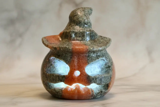 Serpentine Jack O Lantern crystal carving with green and orange inclusions