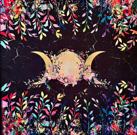 Colorful floral and moon design on dark fabric.