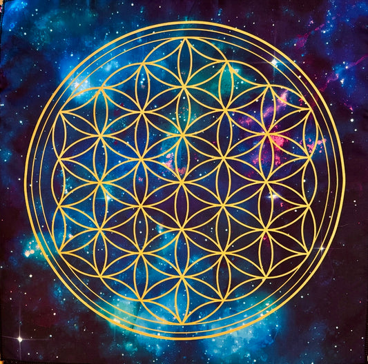 Product shot of a tapestry with a gold flower of life design over a galaxy background.