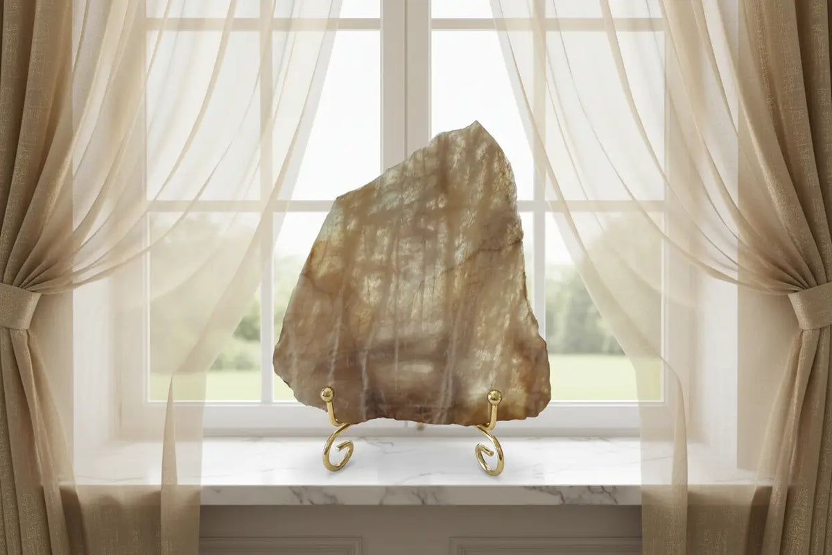 Banded Calcite Slab browns and tans in a window sill with curtains
