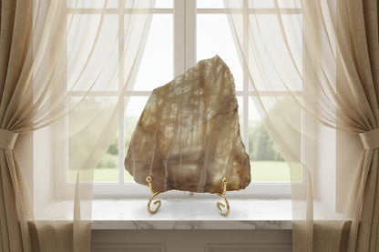 Banded Calcite Slab browns and tans in a window sill with curtains
