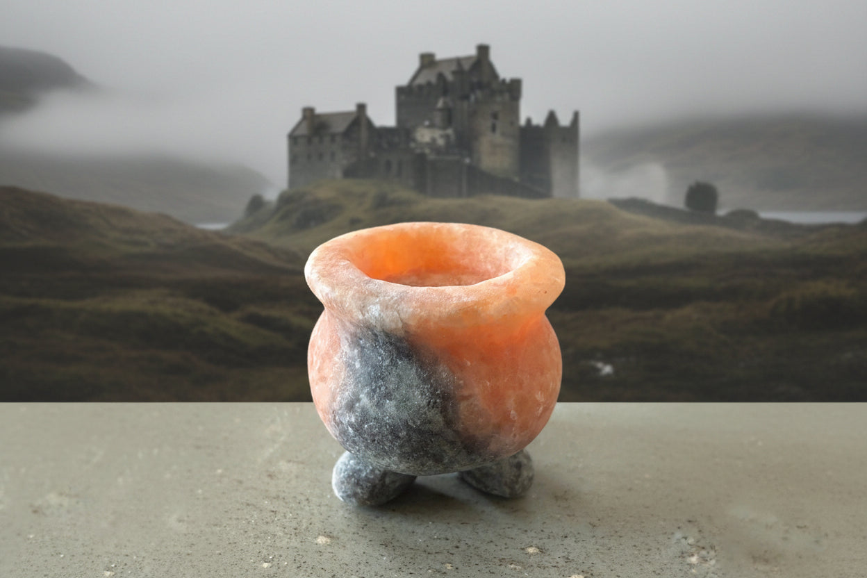 hymialayan salt cauldron with a back drop of an old castle