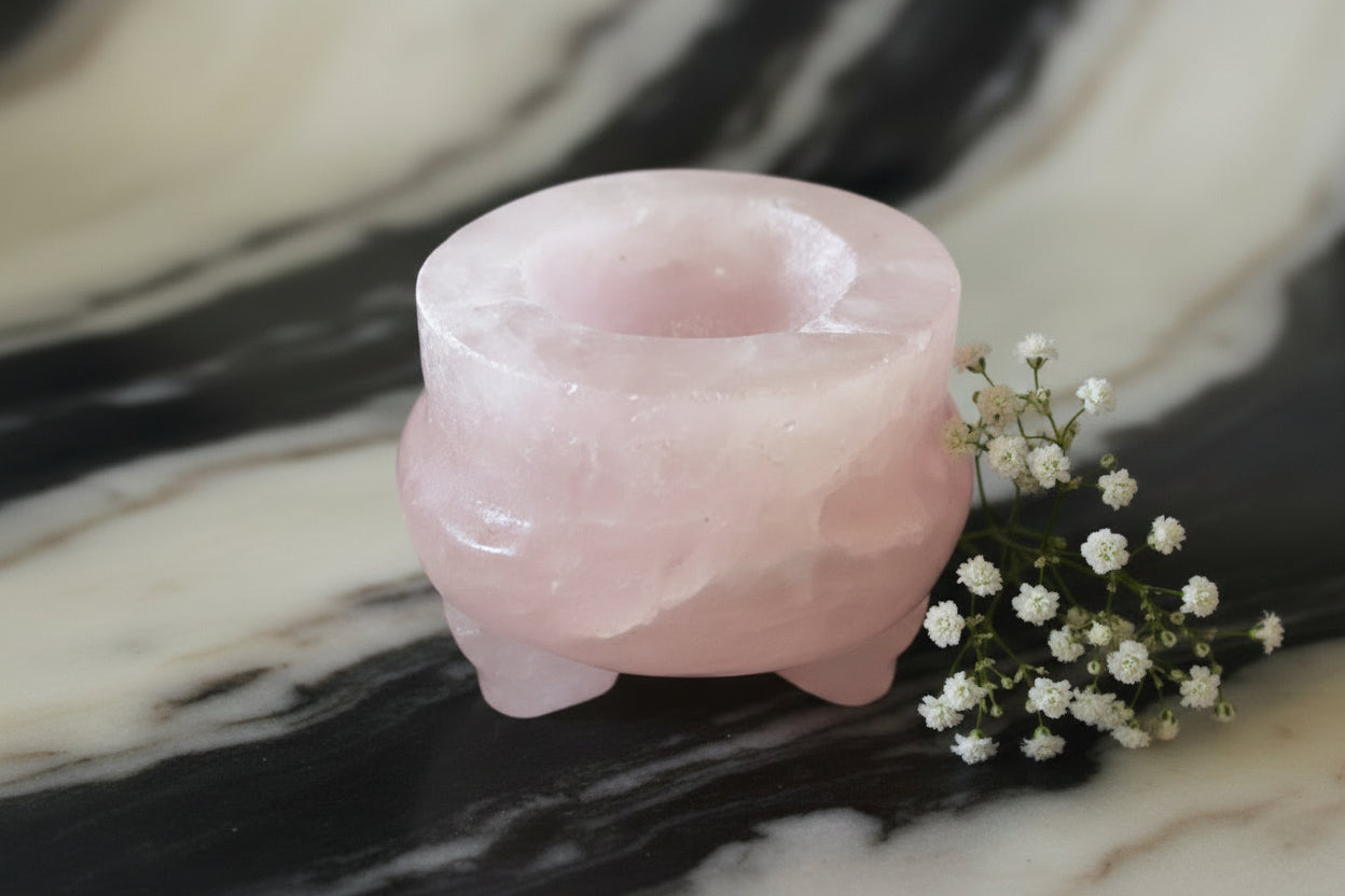 Rose quartz cauldron with flowers and a black and off white background