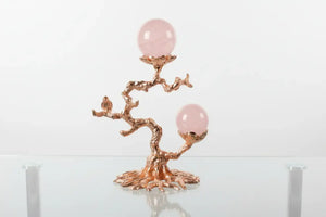 Rose gold tone sphere stand with raven
