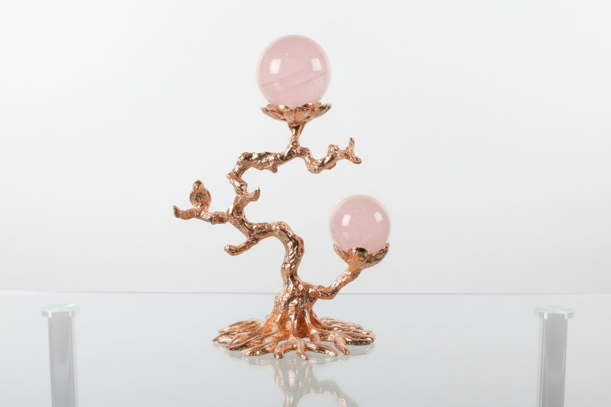 Rose gold tone sphere stand with raven
