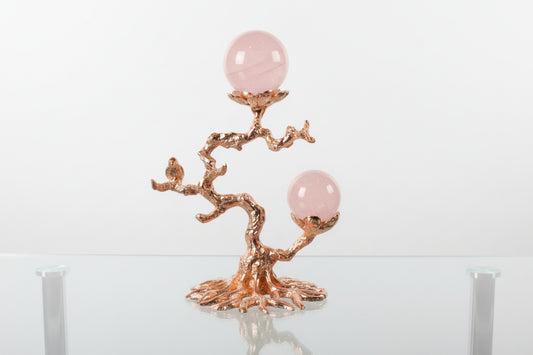Rose gold tone sphere stand with raven
