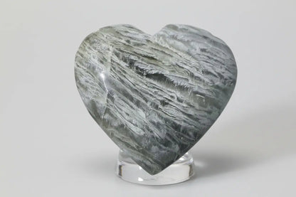 thousand layer garden quartz carved heart in a glass stand