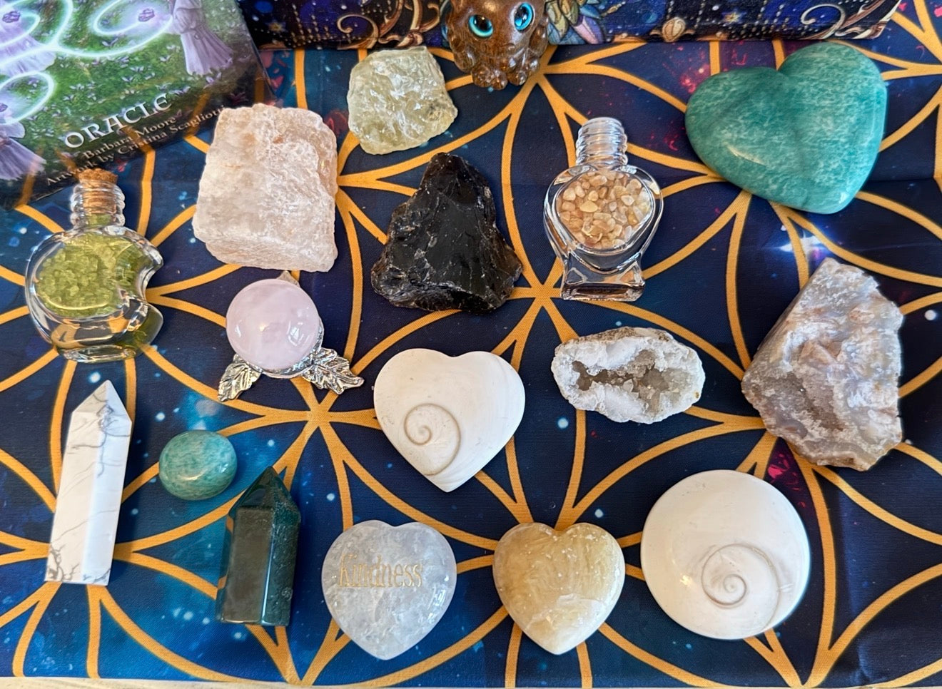 Assorted crystals arranged with Earth Wisdom wooden travel box