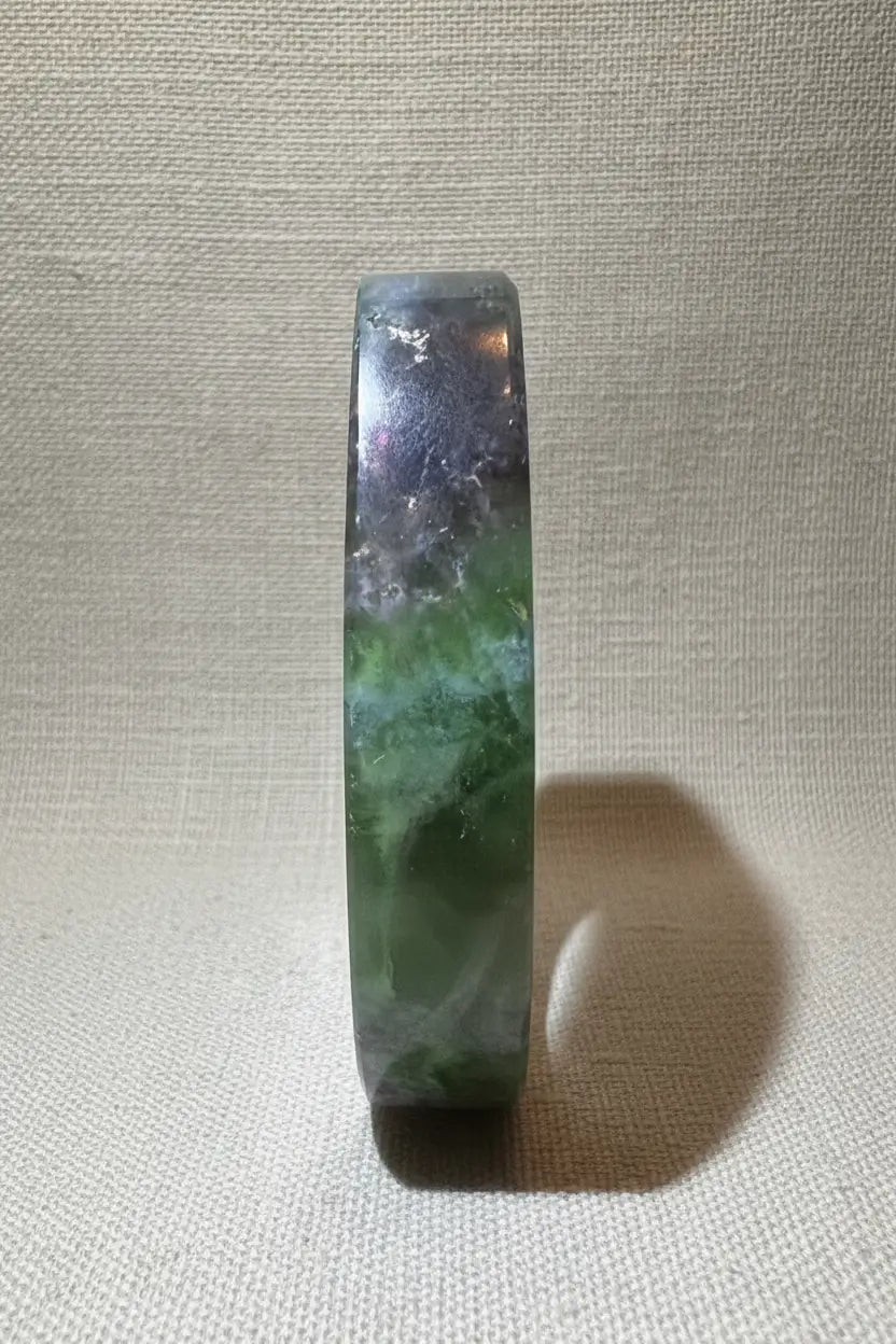 Green and purple fluorite freeform crystal side view