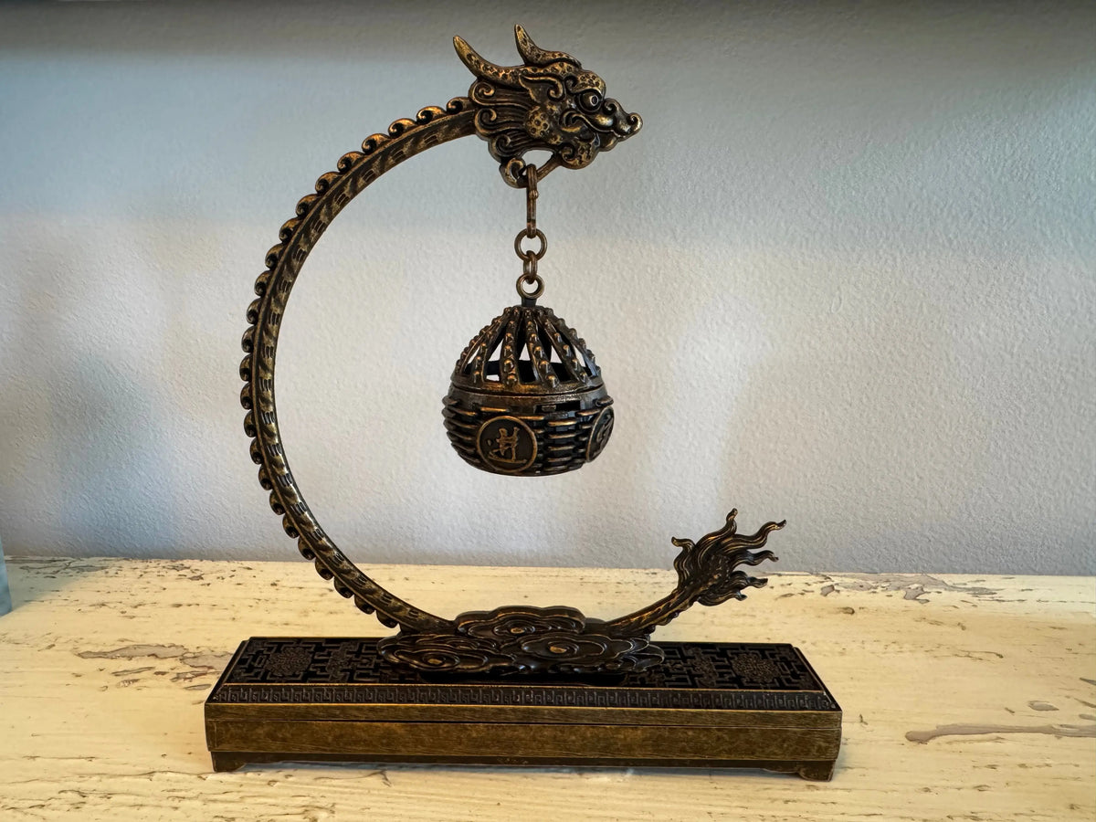Brass dragon incense holder with spherical burner close-up