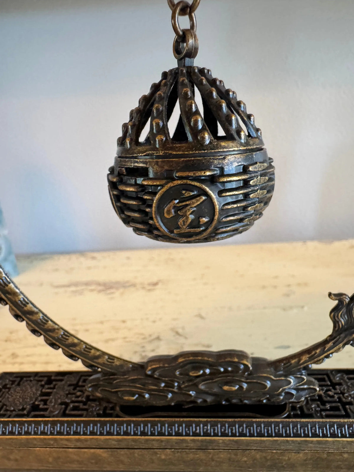 Brass dragon incense holder with open lattice sphere