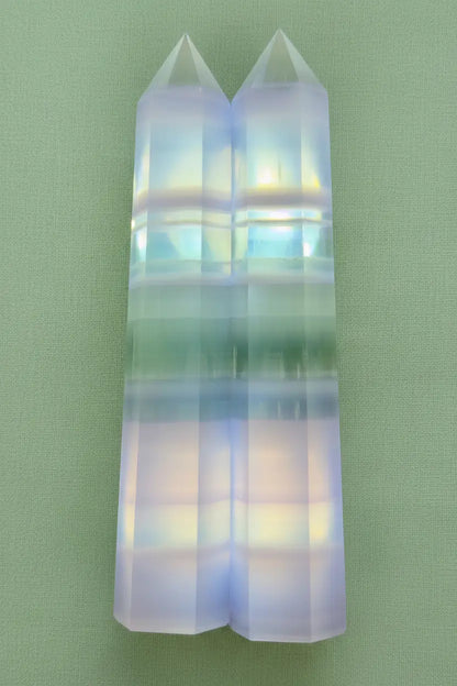 Two color zone fluorite towers cut from the same slab.  bands are identical purple, green, white 
