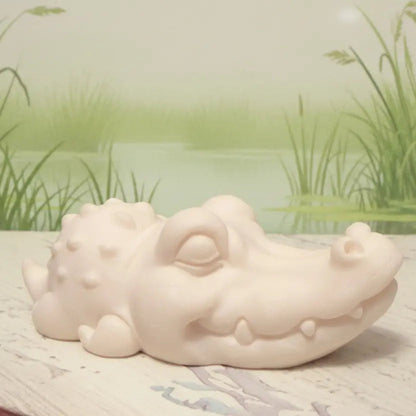 Carved tagua nut crocodile with a pretty marsh behind 