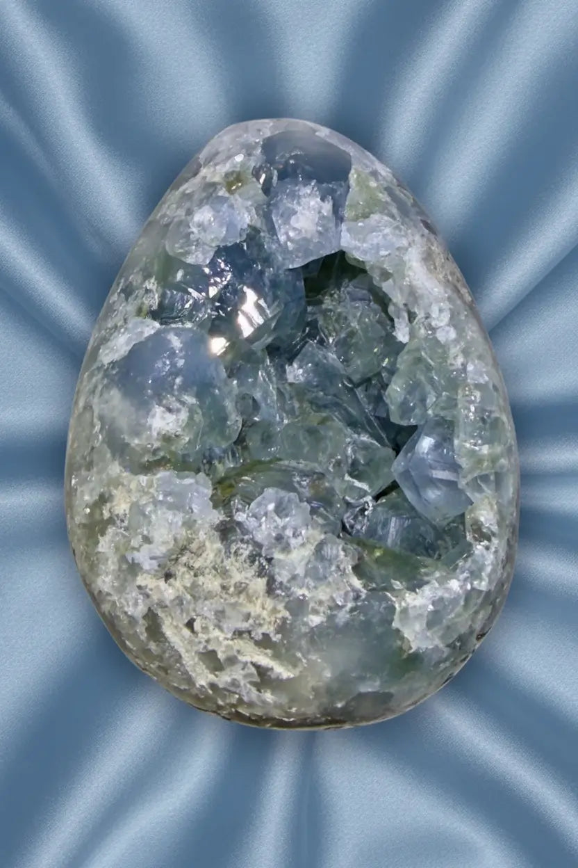 Blue celestine natural geode crystal on blue cloth