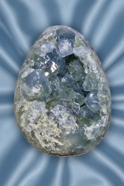 Blue celestine natural geode crystal on blue cloth