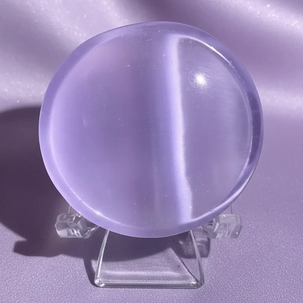 close up of a lavender chatoyant selenite petite bowl on a stand