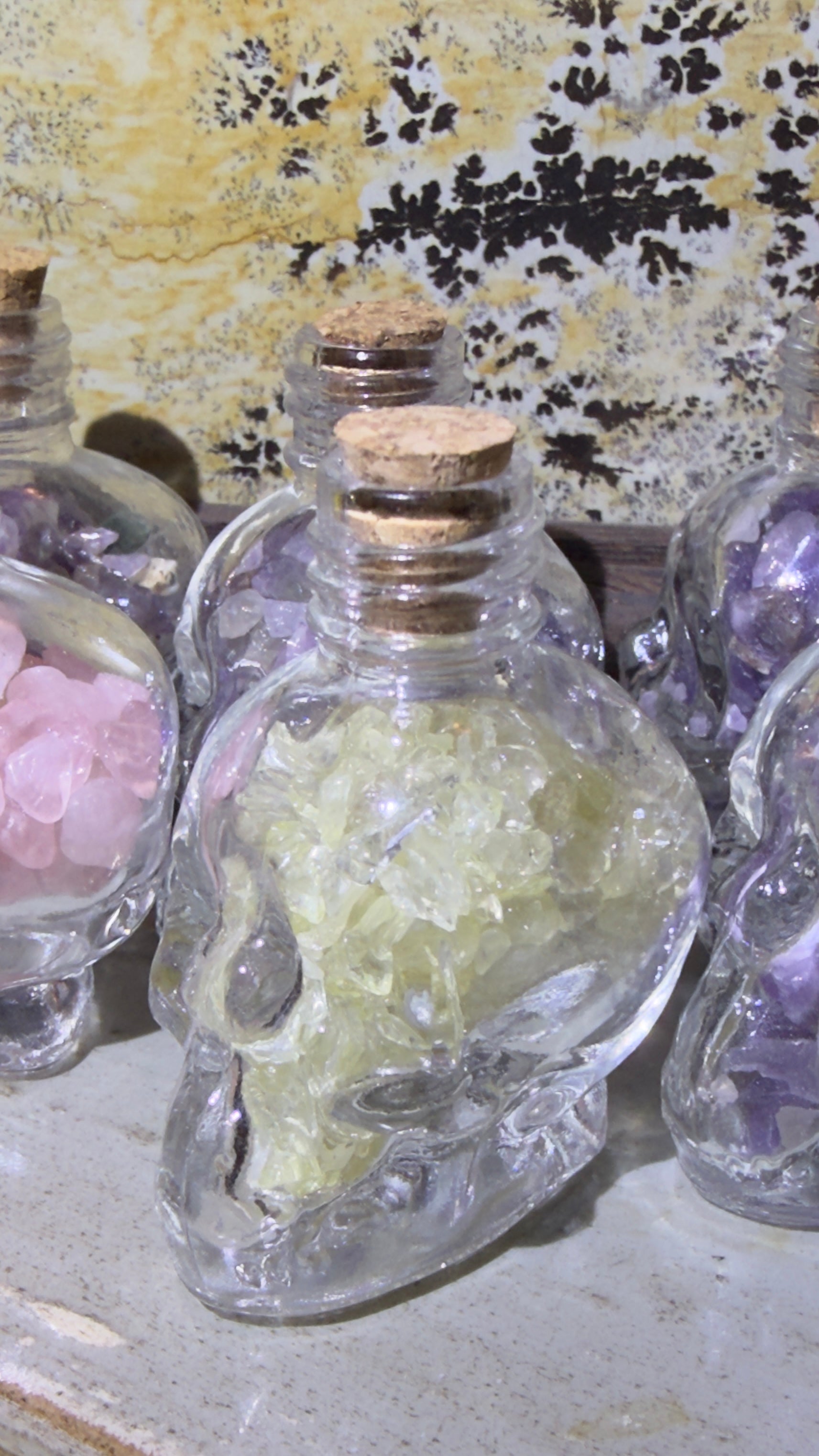 Citrine crystal chips in a glass skull shaped wish bottl 