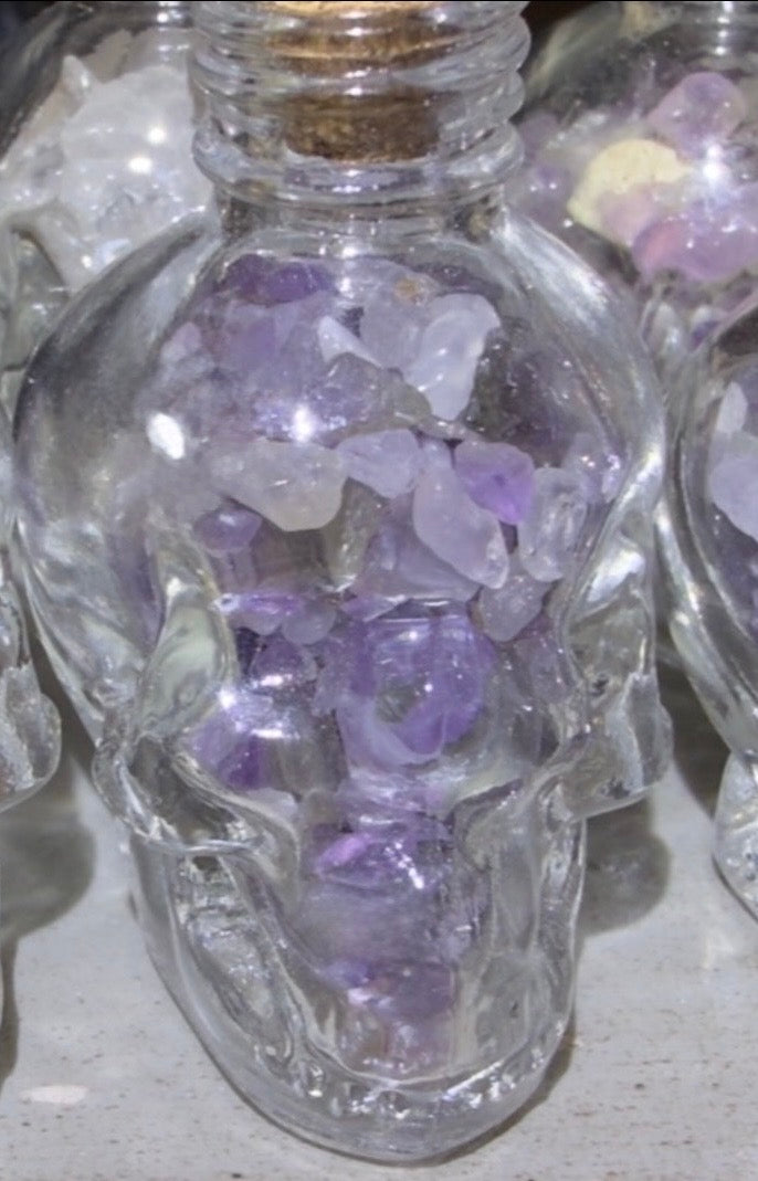 Amethyst crystal chips in a skull shaped glass wish bottle 