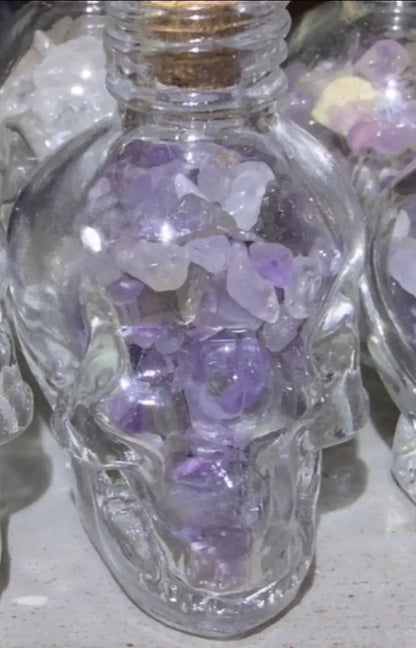 Amethyst crystal chips in a skull shaped glass wish bottle 