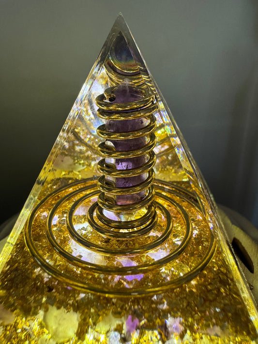 Amethyst and Copper Wire Orgonite Pyramid filled with chips of copper, natural amethyst crystals and a spiral copper wire 