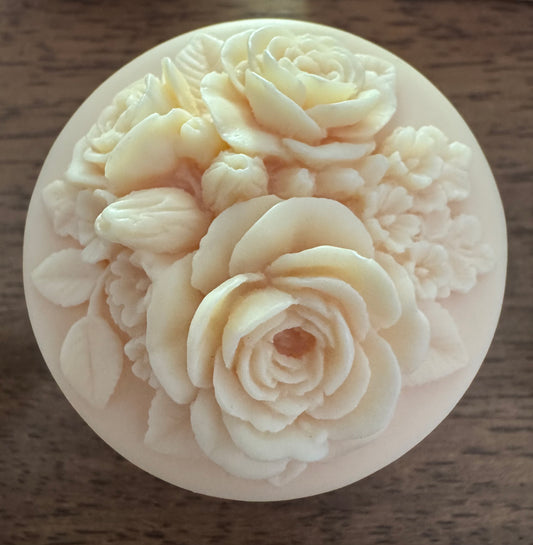 Round decorative soap with floral carvings.