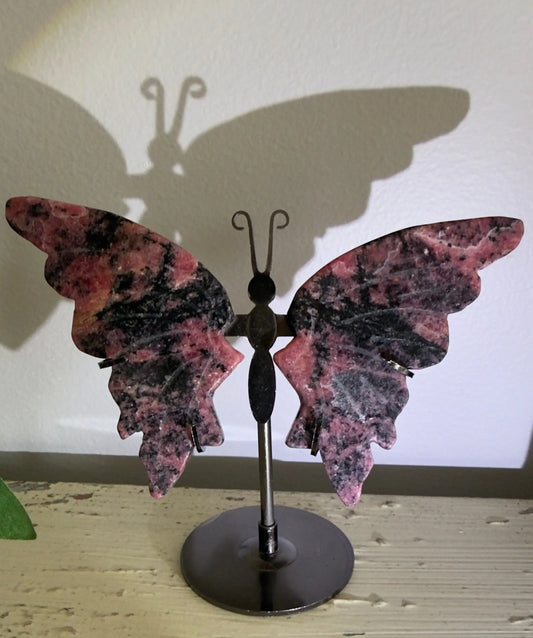 Rhodonite butterfly wing carving on black metal stand