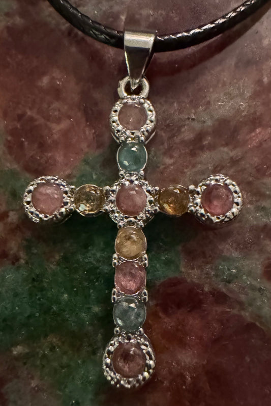 Gemstone cross pendant necklace on display.