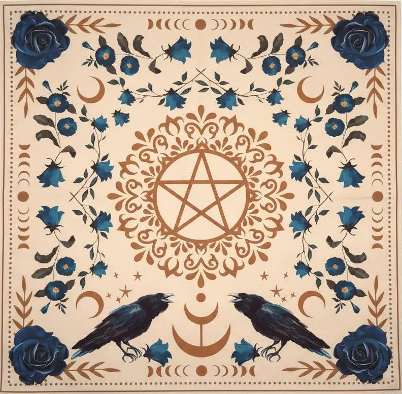 A square printed cloth featuring a cream background with blue roses, crows, crescent moons, floral motifs, and a central pentagram design.