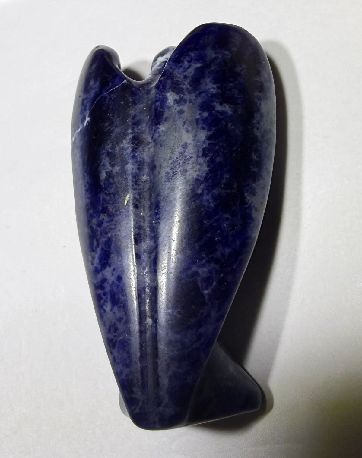 view of back sodalite carved angel. natural veins of calcite - not a crack