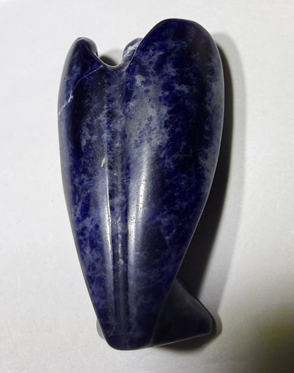 view of back sodalite carved angel. natural veins of calcite - not a crack