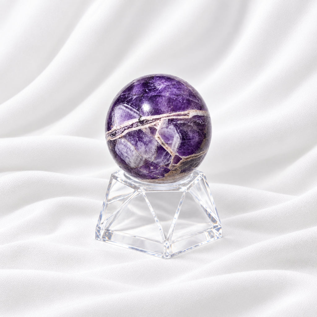 close up amethyst sphere showing natural fractures and clear quartz inside