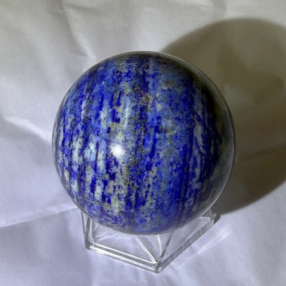 natural lapis lazuli carved sphere with pyrite, deep blues, and white banding